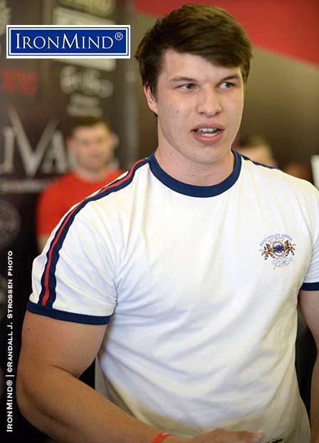 An avid reader, Alexander Kudashkin—who is 22 years old, stand 190 cm (6’ 3”) tall and weighs 106.6 kg (235 lb.)—certified on the Captains of Crush No. 3 gripper after slamming it shut at the 2015 WAA Armlifting World Championships in St. Petersburg, Russia. IronMind® | ©Randall J. Strossen photo