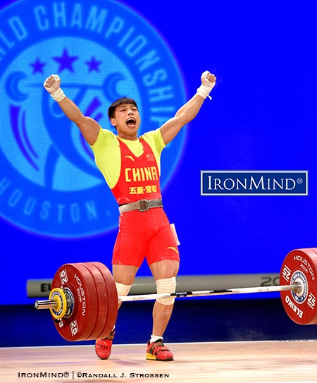 Chen Lijuan (China) celebrates breaking two world records in the men’s 62-kg category of the IWF World Championships in Houston, Texas. IronMind® | ©Randall J. Strossen photo