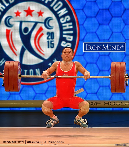 Om Yun Chol attacked a 175-kg clean and jerk on his third attempt in the 56-kg category at the 2015 IWF World Championship in Houston. IronMind® | ©Randall J. Strossen photo
