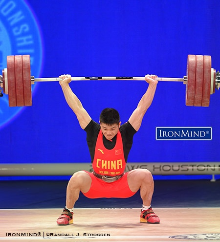 After losing control of the jerk on his second attempt, Shi Zhiyong, oozing confidence, repeated with the same 190 kg on his third attempt and stuck the lift at the IWF World Championships in Houston—where he won two gold medals in the men’s 69-kg category. IronMind® | ©Randall J. Strossen photo