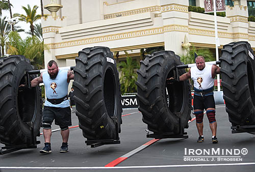 Eddie Hall (left) and Lauri Nami (right) battle it out in the Yoke Race during the qualifying round of the 2014 World’s Strongest Man contest. IronMind® | Randall J. Strossen photo