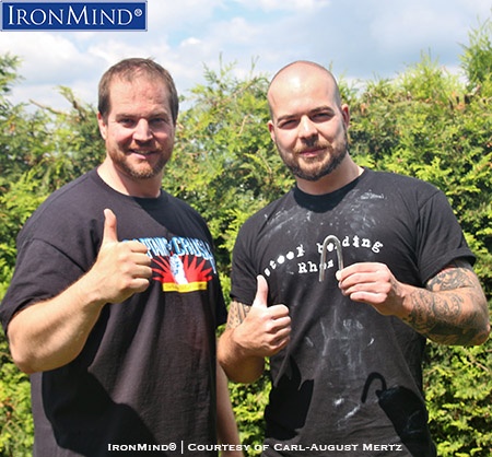 Jan Heller (right) has just been certified on the IronMind Red Nail and after his official bend, his referee, Carl-August Mertz (left), who is certified on both the Red Nail and the Captains of Crush No. 3 gripper, hosted a barbecue. IronMind® | Photo courtesy of Carl-August Mertz