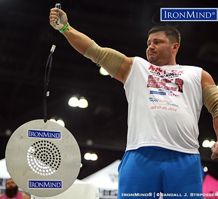 Alexey Tyukalov shown competing on the CoC (Captains of Crush) Silver Bullet Hold at the 2014 Los Angeles FitExpo. Tyukalov will be competing at the Chicago FitExpo next month at Odd Haugen’s grip contest. IronMind® | ©Randall J. Strossen photo