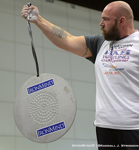 Establishing the world standard, Clay Edgin held the CoC Silver Bullet for 5.62 seconds using a Captains  of Crush No. 4 gripper in an exhibition at Odd Haugen’s grip contest at the Los Angeles FitExpo this past weekend. IronMind® | ©Randall J. Strossen photo