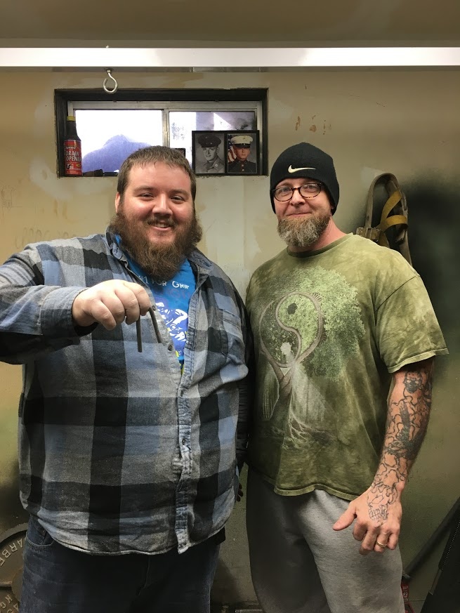 27-year old Joshua Grass (left) has just been certified on the IronMind Red Nail, bending this benchmark piece of steel on his official attempt, refereed by Jesse Coffin (right). Grass stands 5’ 11” tall and weighs 417 lb.  IronMind® | Photo courtesy of Joshua Grass