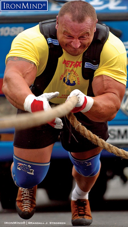 Shown on the bus pull at World’s Strongest Man 2006 (Sanya, China), Mariusz Pudzianowski (Poland) has strongman credits that include an unmatched five World’s Strongest Man titles: he was ranked number two on the Fortissimus All-Time Strongman Rankings. IronMind® |©Randall J. Strossen photo