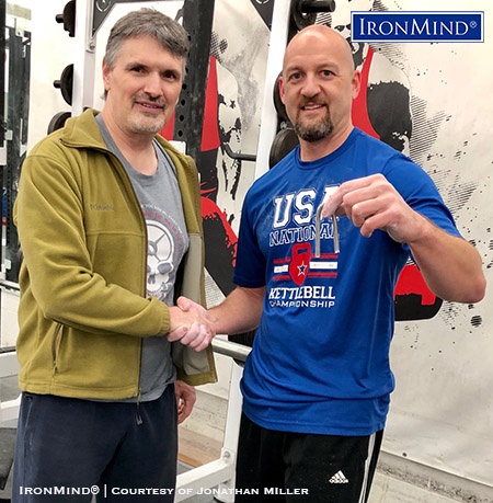 Jonathan Miller (right) has just been certified on the IronMind Red Nail, a benchmark steel bend. Heath Watts (left) refereed Miller’s official attempt. IronMind® | Photo courtesy of Jonathan Miller