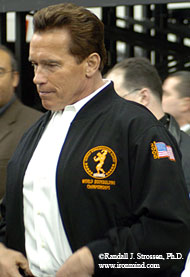 On his way to yet another appearance, the world's most famous governor, Arnold Schwarzenegger, emerges into the service corridor behind the main expo stage at the 2005 Arnold Fitness Weekend. IronMind® | Randall J. Strossen, Ph.D. photo.