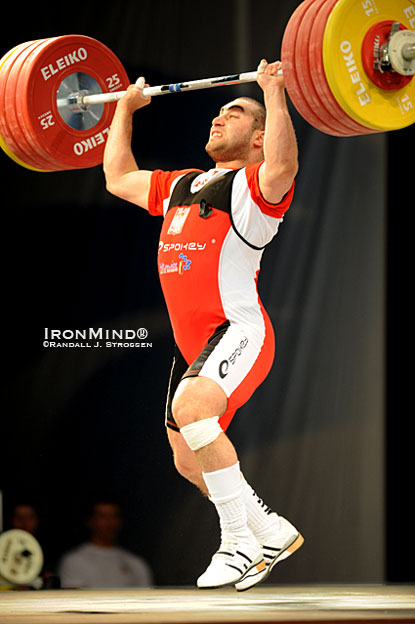 Feet flying, 94-kg Arsen Kasabijew (Poland) splits under this 211-kg jerk at the 2010 European Weightlifting Championships.  The feet are the focus of this month's column by Jim Schmitz, a three-time coach of the USA Olympic weightlifting team.  IronMind® | Randall J. Strossen photo.