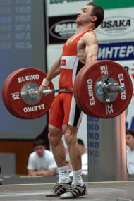 56-kg Sedat Artuc (Turkey) finishing his pull on his third attempt snatch, 125 kg, on his way to victory at the 2005 European Weightlifting Championships. IronMind® | Randall J. Strossen, Ph.D. photo.