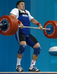 Good enough for the gold medal, Dmitry Berestov pulls himself under 230-kg in the clean and jerk. IronMind® | Randall J. Strossen, Ph.D. photo.