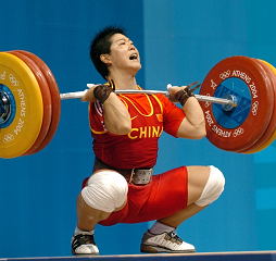 Liu Chunhong (China) hits the bottom with her 153-kg clean and jerk. This lift broke the Olympic, junior world and senior world records in both the clean and jerk and in the total. IronMind® | Randall J. Strossen, Ph.D. photo.