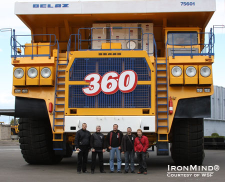 WSF Strongman Federation founder Vlad Redkin (second from the left) gives us an idea of what it means to say they build big trucks at BelAZ.  IronMind® | Courtesy of WSF World Cup.