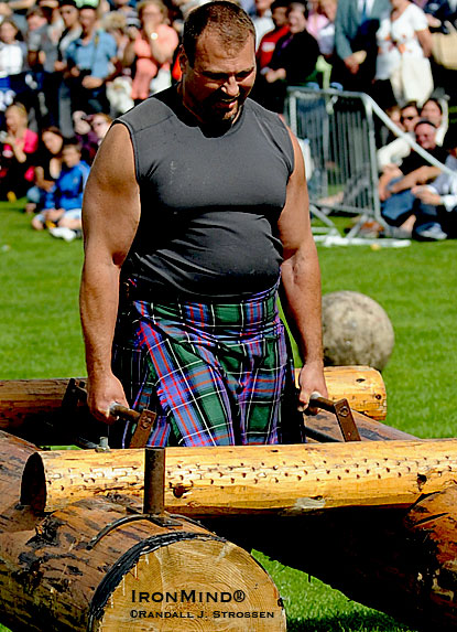 Bill Crawford, M.D. took a brief break from stone lifting as he was part of the team demonstrating strongman events at the 2009 IHGF World Heavy Events Championships.  IronMind® | Randall J. Strossen photo.