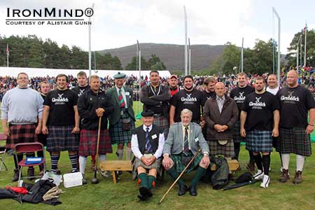 2013 Royal Braemar Highland Games group photo: heavy events winner Scott Rider is third from the left, front row.  IronMind® | Photo courtesy of Alistair Gunn