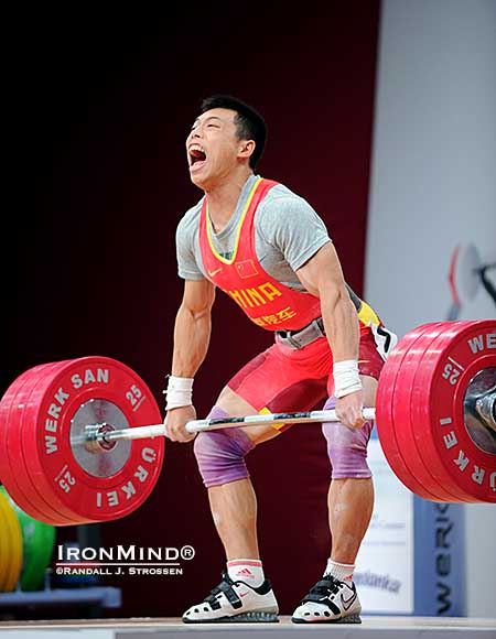 Chen Lijun (China) takes 175 kg for a ride—back to the wall, he made this clean and jerk, good for the silver medal in the jerk and the gold medal in the total at the 2013 World Weightlifting Championships.  IronMind® | Randall J. Strossen photo
