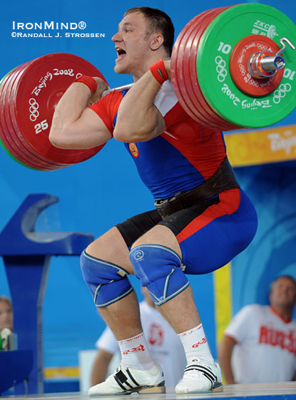 Russia’s Evgeny Chigishev on his way up with 250 kg on his final attempt at the 2008 Olympics, where he went six-for-six with sensational lifts of 210 kg in the snatch and 250 kg in the clean and jerk, while weighing just over 124 kg.  IronMind® | Randall J. Strossen photo.