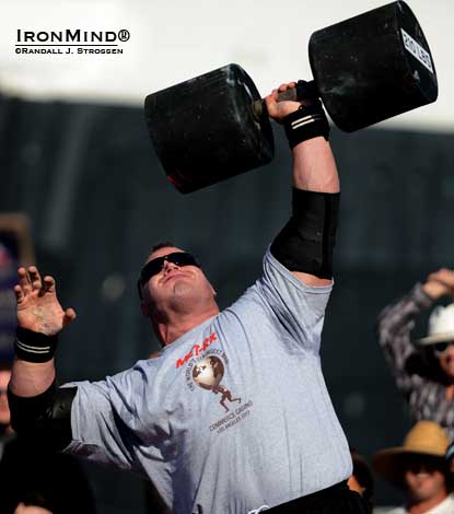 Derek Poundstone set a world record in the Giant Dumbbell Press at the 2012 World’s Strongest Man contest.  Will he be able to qualify for WSM 2013 this weekend, flying on one wing?  IronMind® | Randall J. Strossen photo.  