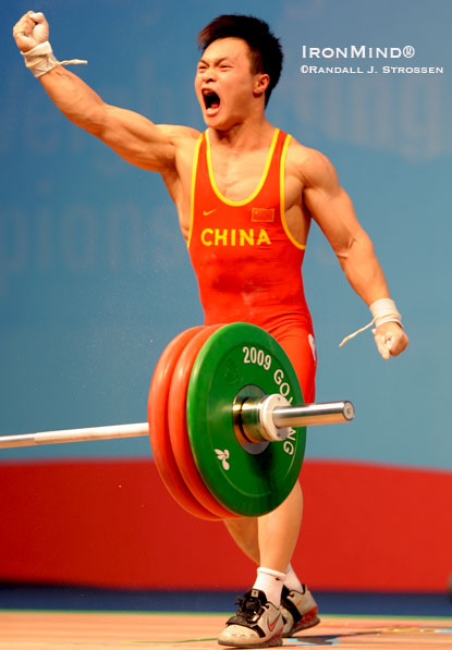 Ding Jianjun (China) celebrates his gold medal 146-kg snatch in the men’s 62-kg class at the World Weightlifting Championships.  IronMind® | Randall J. Strossen photo.