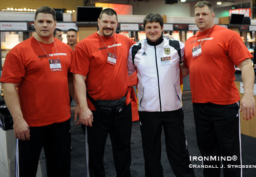 Left to right: Wade Gillingham, Karl Gillingham, Matthias Steiner, and Brad Gillingham, at the GNC booth at the 2009 Arnold.  Surrounded by around half a ton of Gillinghams, Matthias Steiner - the 2008 super heavyweight Olympic gold medalist in weightlifting said, “I feel like a little boy.”  Grip strength, strongman, Olympic-style weightlifting and powerlifting - there’s a lot of talent in this photo.  IronMind® | Randall J. Strossen photo. 