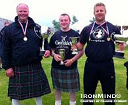   Craig Sinclair (left) was presented with the Clan Gunn Society Cup for Combined Distances in the Hammer, Jamie Gunn (center) was presented with the John Budge Cup for most points confined to Caithness, and Scott Rider (right) was presented with the Andrew Ross Memorial Cup for the most points open and the NNC Cup for the 28-lb. weight-for-distance.  IronMind® | Photo courtesy of Francis Brebner.