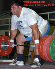 Hossein Rezazadeh starts a 240-kg clean and jerk on its upward journey in the training hall at the 2005 Asian Weightlifting Championships (Dubai, UAE). IronMind® | Randall J. Strossen, Ph.D. photo.