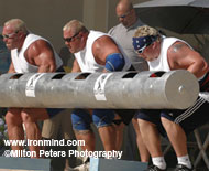 (Left to right) Jon Andersen (USA), Van Hatfield (USA) and Geoff Dolan (Canada) combine forces in the three-man log. IronMind® | Photo courtesy of Milton Peters Photography.