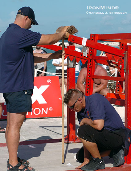 Using a high-tech measuring tool, Ilkka Kinnunen (left) works with Marcel Mostert (right) at WSM 2004, where the team does some precision mapping for the barrel squat apparatus.  IronMind® | Randall J. Strossen photo.