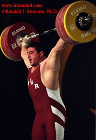 Saeed Salem Jaber (Qatar) snatches 210 kg at the 2003 World Weightlifting Championships (Vancouver, British Columbia). The world's top super heavyweights are capable of snatching over 210 kg, and cleaning and jerking over 260 kg - weights that once lifted are then dropped from arm's length overhead, which makes world-class weightlifting a supreme testing ground for the world's best barbells. IronMind® | Randall J. Strossen, Ph.D. photo.