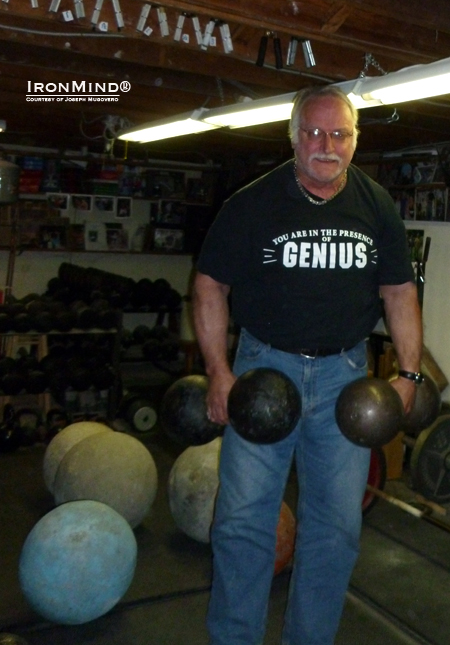 Grip strength advocate and practitioner, 63-year young Joe Mugovero lifts a replica Inch dumbbell for fun, racking up rep after rep.  Here, he lofts the replica and another one that can loaded with shot.  IronMind® | Courtesy of Joseph Mugovero.