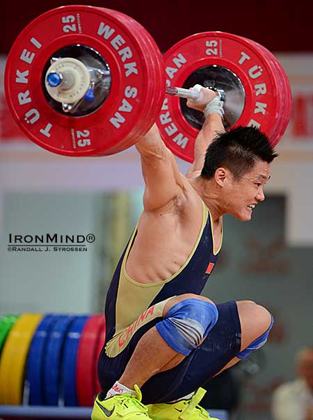 77-kg weightlifter Lyu Xiaojun hits the bottom with a 176-kg world record snatch locked out overhead.  IronMind® | Randall J. Strossen photo