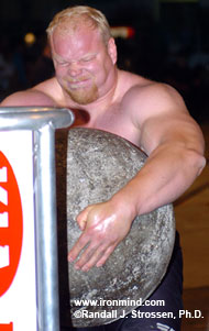 Working away at the 2004 World Muscle Power Championships (Dolbeau-Mistassini, Quebec): When Magnus "The Stone King" Samuelsson wraps his hands and arms around a stone, it's something like an anaconda latching onto its next meal. IronMind® | Randall J. Strossen, Ph.D. photo.