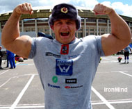 Three-time World's Strongest Man winner Mariusz Pudzianowski, modeling a Russian Army hat, hits a double biceps pose in front of Moscow's Olympic Stadium. IronMind® | Colin Bryce photo. Three-time World's Strongest Man winner Mariusz Pudzianowski, modeling a Russian Army hat, hits a double biceps pose in front of Moscow's Olympic Stadium. IronMind® | Colin Bryce photo.