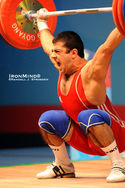 Olympic-style weightlifting is a pretty minimalist pursuit: one person against a barbell, with no spotters or extraneous equipment, but one glance at Armenia’s Tigran Martirosyan (shown snatching 170 kg in the 77-kg class at the 2009 World Weightlifting Championships) and you can see that you still need shoes, tape, chalk, wraps . . . making the merits of a good, well-packed gym bag hard to contest.  IronMind® | Randall J. Strossen photo.