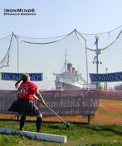 Michele Green winds up on the hammer, with the Queen Mary keeping an approving eye on the action.  IronMind® | Francis Brebner photo.