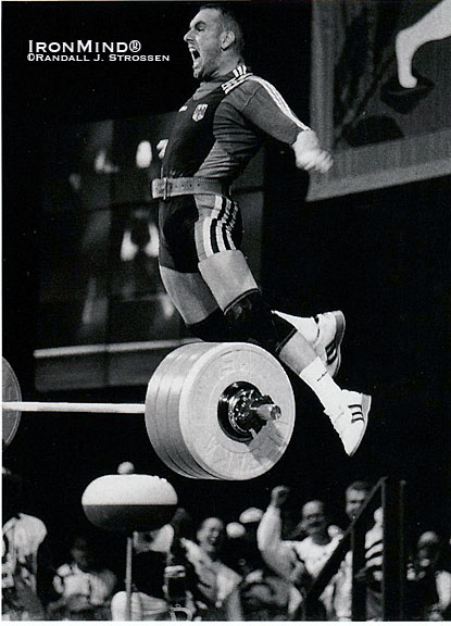 Marc Huster celebrates his world record 213.5-kg clean and jerk in the 83-kg class at the 1996 Olympics.  When Randall Strossen once asked Marc Huster if he’d ever considered a career as a high jumper, the ebullient weightlifter said, “Maybe a kangaroo.”  IronMind® | Randall J. Strossen photo.