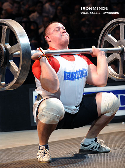 Putting his Olympic-style weightlifting background to good use in a strongman contest, Mikhail Koklyaev squat cleans the IronMind® Apollon’s Axle™ at the recent Giants Live competition held at the Mohegan Sun.  IronMind® | Randall J. Strossen photo.