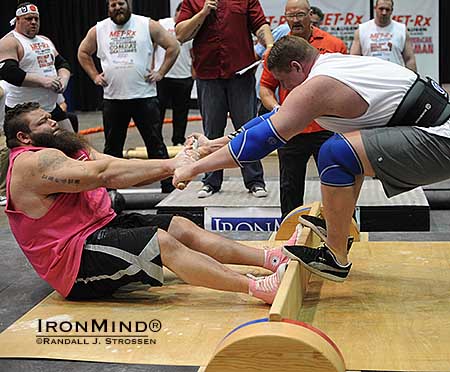 Robert “OB” Oberst (left) launches James Rude at the Mas wrestling event which was part of the 2013 Odd Haugen Strength Classic at the Los Angeles FitExpo.  IronMind® | Randall J. Strossen photo
