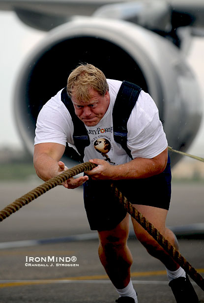 World’s Strongest Man winner Phil Pfister fills a doorway and he can slide a U.S. quarter through his wedding ring, to give you an idea of what we’re talking about structurally, which is why when his wife says, “What did you do at work today?”  Phil can say, “I pulled a plane.”  Strongman is a perfect fit for a guy like Pfister who fills a Carhartt 4XLT jacket as naturally some people would deflate to an XL.  IronMind® | Randall J. Strossen photo.