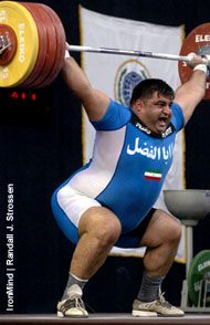 Hossein Rezazadeh (Iran) snatches 210 kg at the 2005 World Weightlifting Championships (Doha, Qatar), a rather routine weight for the two-time Olympic gold medalist. Evgeny Chigishev (Russia) snatched the gold, however, with a very impressive 211. Who will be the top super this year? IronMind® | Randall J. Strossen, Ph.D. photo.