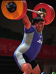 Hossein Rezazadeh (Iran) on his way up with a world record 213-kg snatch at the 2003 Asian Weightlifting Championships (Qinhuangdao, China). IronMind® | Randall J. Strossen, Ph.D. photo.