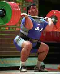 Hossein Rezazadeh racking 250 kg at the 2003 Asian Weightlifting Championships (Quinhuangdao, China). IronMind® | Randall J. Strossen, Ph.D. photo. 