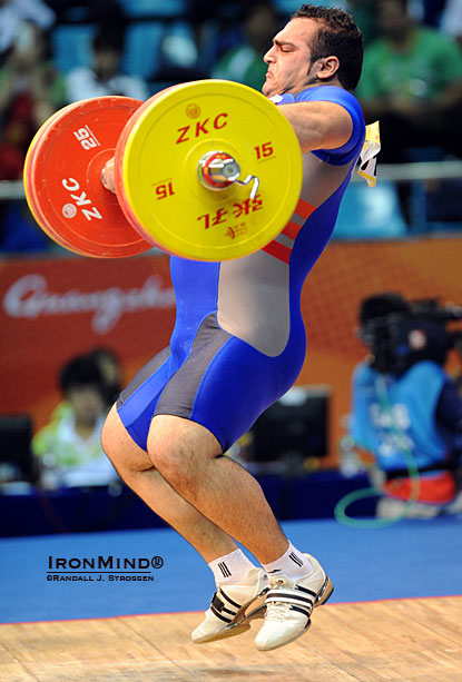 Behdad Salimi (Iran), shown in midflight with his 205-kg snatch at the 2010 Asian Games, won the supers at the recent Asian Weightlifting Championships via a 208-kg snatch and a 250-kg clean and jerk.  IronMind® | Randall J. Strossen.