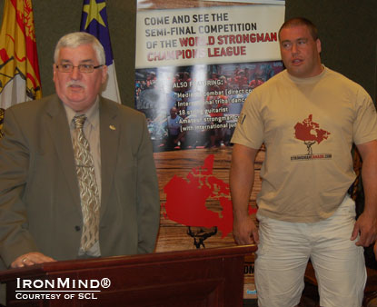 St. John, New Brunswick mayor Ivan Court (left) introduces the SCL–Canada strongman competition with backup provided by top Canadian strongman Christian Savoie (right).  IronMind® | Courtesy of SCL.