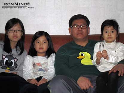 “Look at what my dad can do?”  Sun-gil Gwon’s daughter holds up the IronMind Red nail that her father officially bent.  IronMind® | Photo courtesy of Sun-gil Gwon.