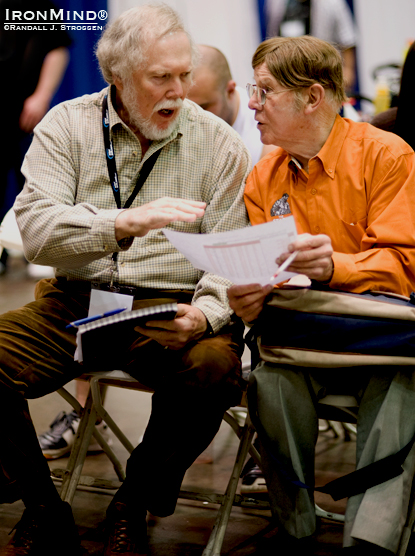 There’s a lot of iron game history on tap in those two seats: Dr. Terry Todd (left) and David P. Webster, OBE (right) compare notes as they watch the action at the FitExpo strongman contest (and the grip contest), with the goal of extending the last two invitations open to the 2011 Arnold strongman contest. IronMind® | Randall J. Strossen photo. There’s a lot of iron game history on tap in those two seats: Dr. Terry Todd (left) and David P. Webster, OBE (right) compare notes as they watch the action at the FitExpo strongman contest (and the grip contest), with the goal of extending the last two invitations open to the 2011 Arnold strongman contest. IronMind® | Randall J. Strossen photo.
