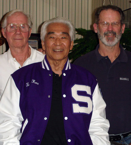 Tommy Kono (center) sports the Sacramento High letter jacket given to him at a 2006 dinner in his honor.  That’s Don Wilson (left) and Jim Schmitz (right) . . . three good reasons why the Pacific Weightlifting Association has the mighty legacy that it does.  IronMind® | Randall J. Strossen photo.