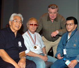 (Left to right) Tommy Kono, Issac Berger, Lou DeMarco and Chuck Vinci relax at the 2004 Arnold. IronMind® | Randall J. Strossen, Ph.D. photo.