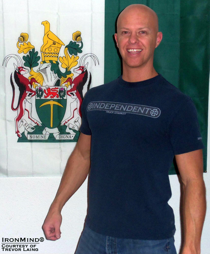 “My picture was taken in front of the Rhodesian flag.  My family emigrated from Rhodesia to America when I was 5; I became an American citizen at age 14.  Rhodesia no longer exists, so there may only ever be one Rhodesian on that [Red Nail] roster,” said Trevor Laing, which makes his mastery of this benchmark short steel bend that much more significant.  IronMind® | Photo courtesy of Trevor Laing.
