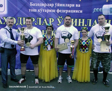 (left to right) Vlad Redkin presents the second place trophy to Alex Lapirev (Belatus).  Kevin Nee (USA) was third and Tarmo Mitt (Estonia) won the first stage of the Asia World Cup strongman series in Uzbekistan.  IronMind® | Courtesy of Vlad Redkin.